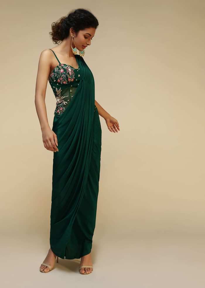 Bottle Green Saree Gown With A Crepe Cowl Drape And Sheer Embroidered Net Bodice With Colorful Resham Flowers