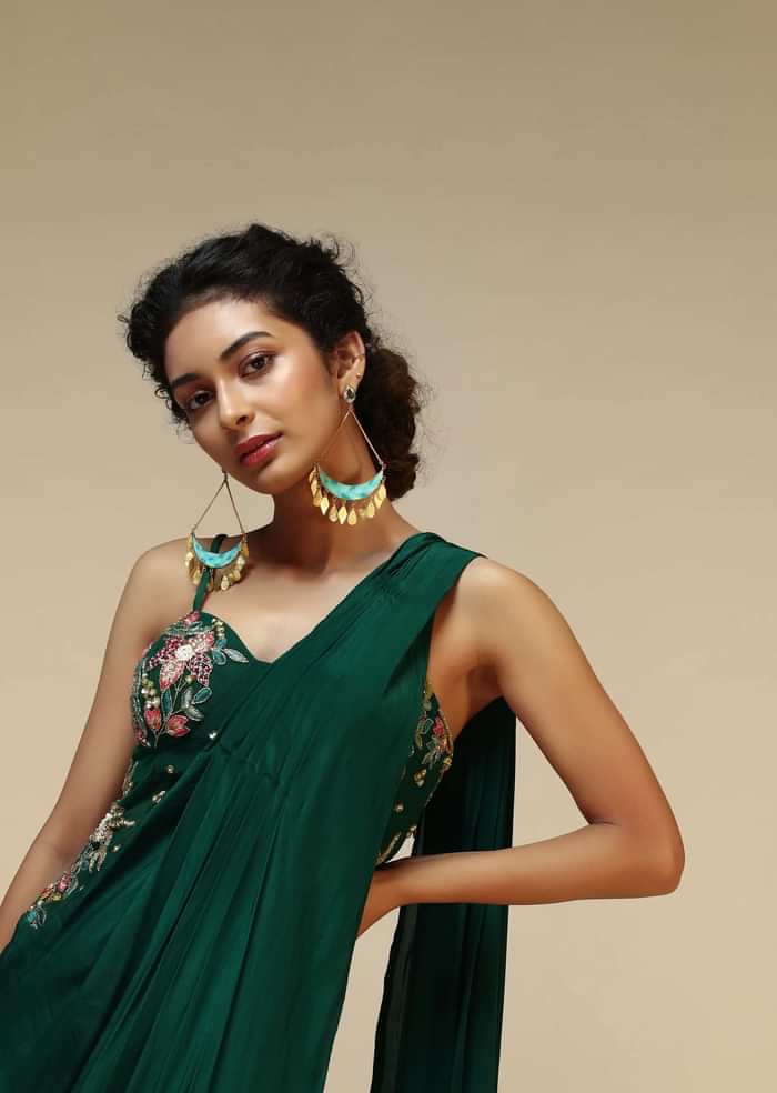 Bottle Green Saree Gown With A Crepe Cowl Drape And Sheer Embroidered Net Bodice With Colorful Resham Flowers