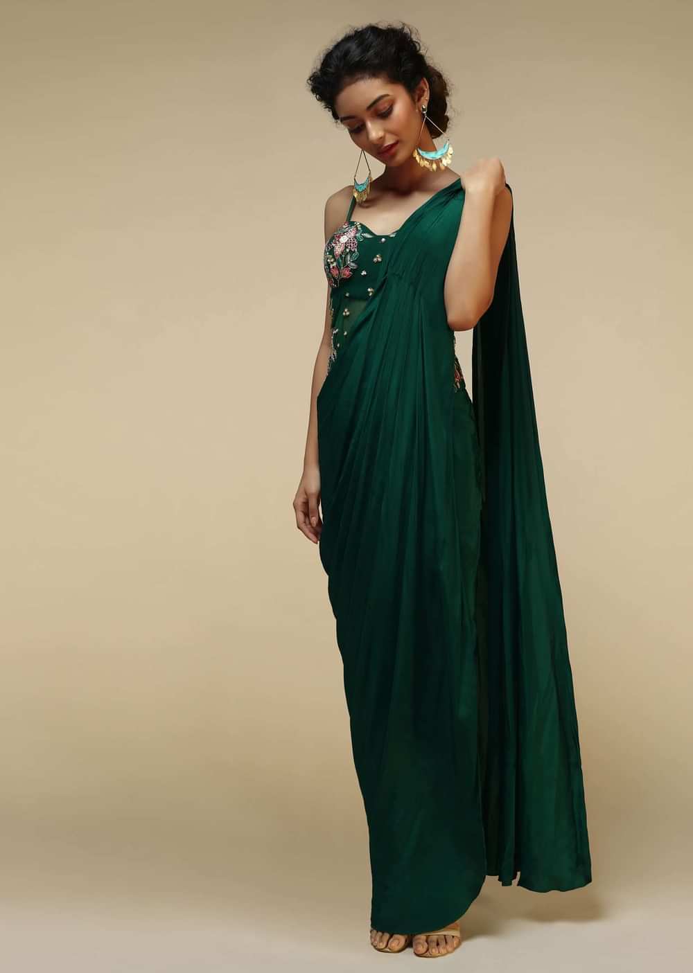 Bottle Green Saree Gown With A Crepe Cowl Drape And Sheer Embroidered Net Bodice With Colorful Resham Flowers