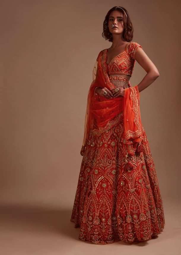 Coral Orange Lehenga Choli In Net With Mirror And Sequins Embroidered Floral And Mughal Embroidery Along With Belt Detailing