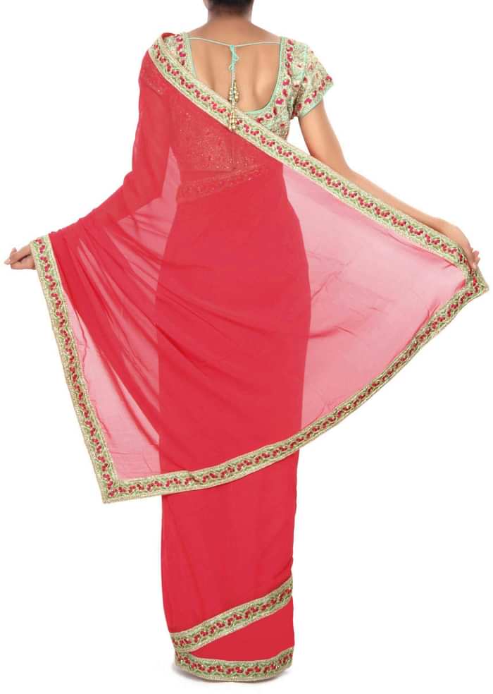 Coral pink saree matched with embroidered blouse only on Kalki