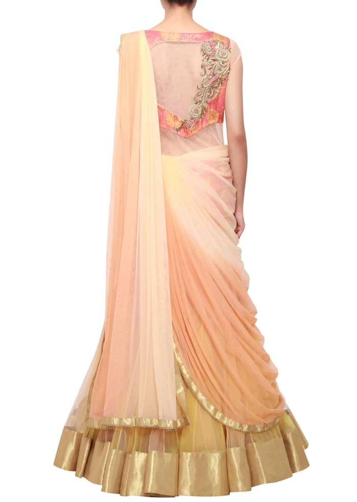 Peachy cream shaded lehenga sari embellished in zardosi only on Kalki