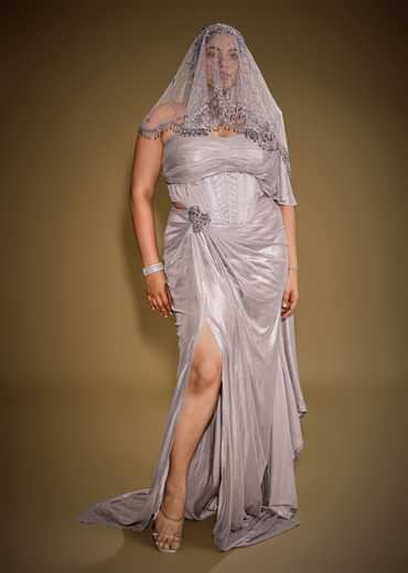 Gold One Shoulder Drape Gown With Embroidered Floral Brooch And Trail