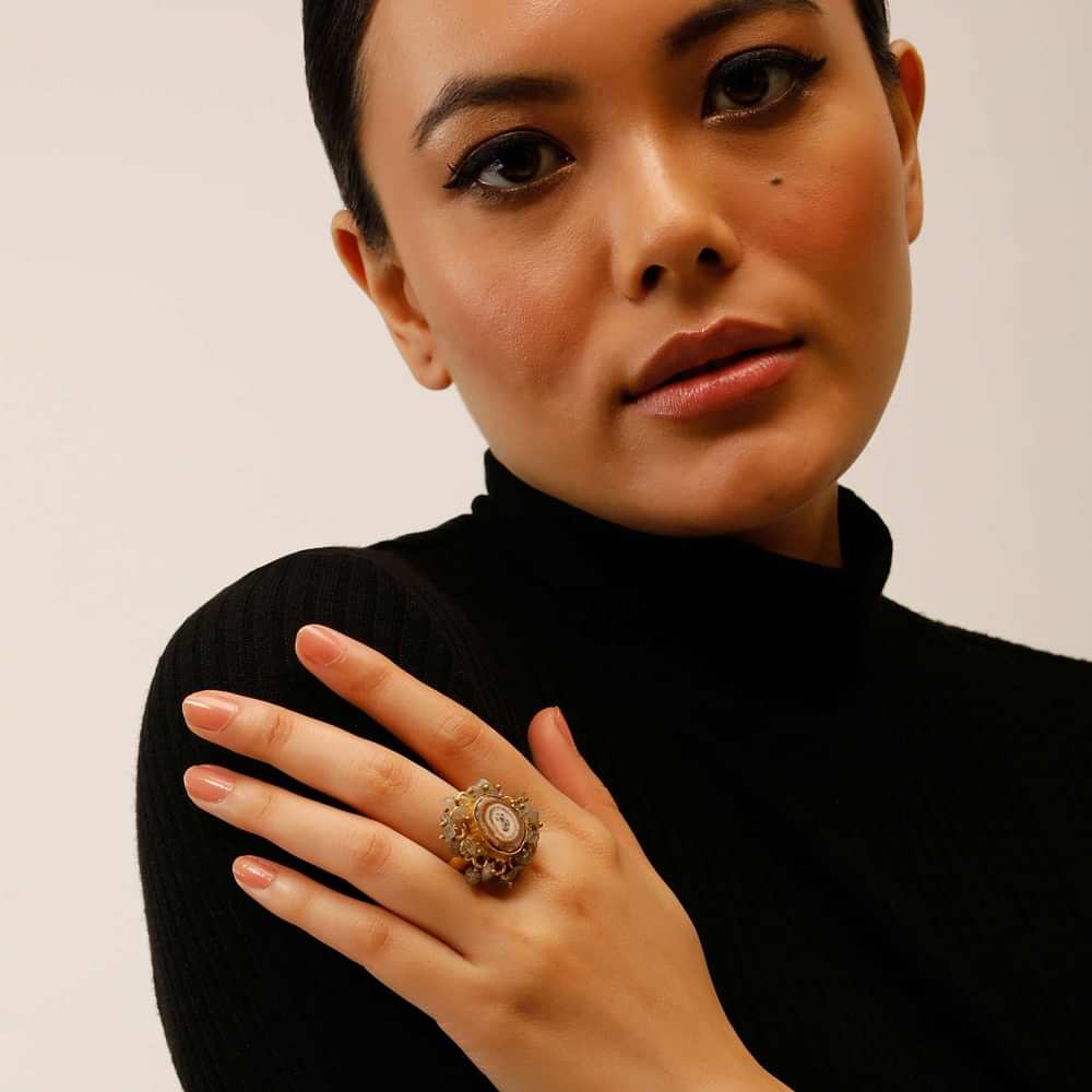 Gold Plated Ring With A Taupe Semi Precious Stone Centre And Tiny Iridescent Stone Pieces All Over