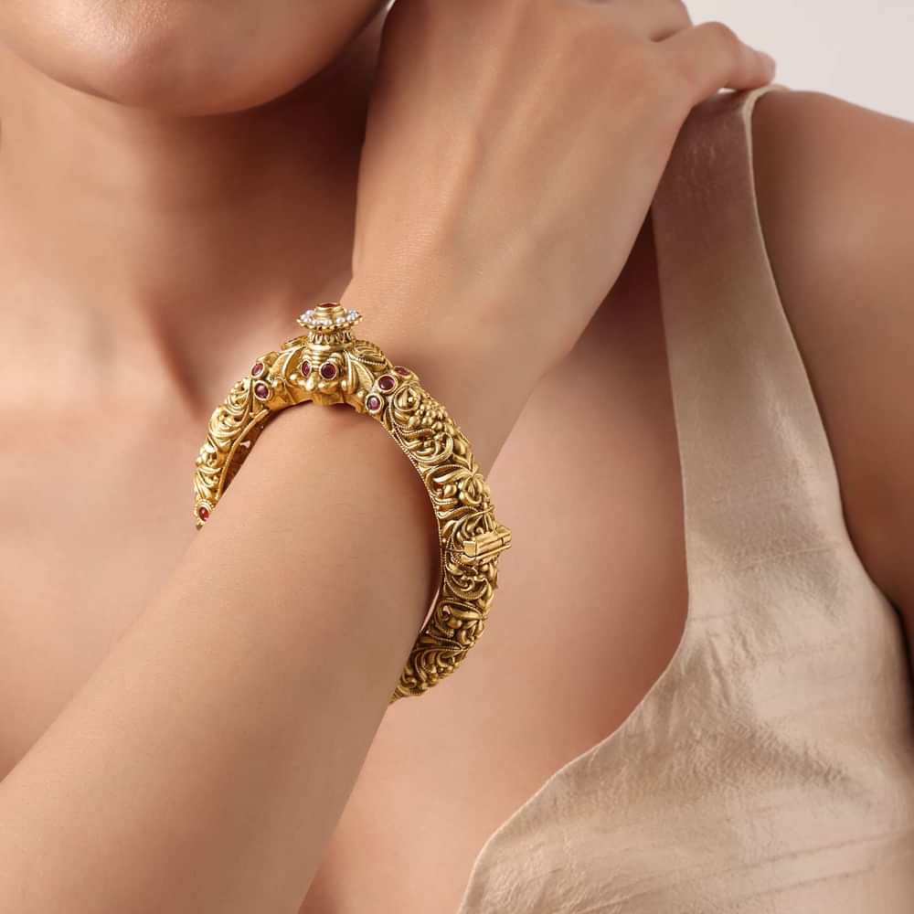 Gold Plated Temple Bangle With Carved Detail And Red Stones