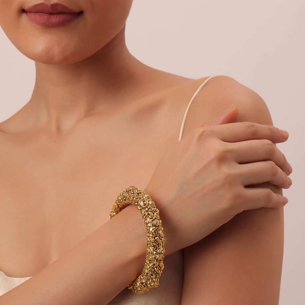 Gold Tone Temple Bangle With Carved Detail