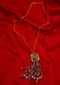 Golden chain necklace with an oval cut out broach with moti, stones and buggle beads