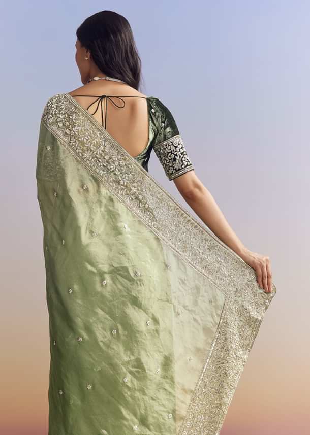 Green Tissue Saree With Velvet Blouse And Richly Embroidered Borders