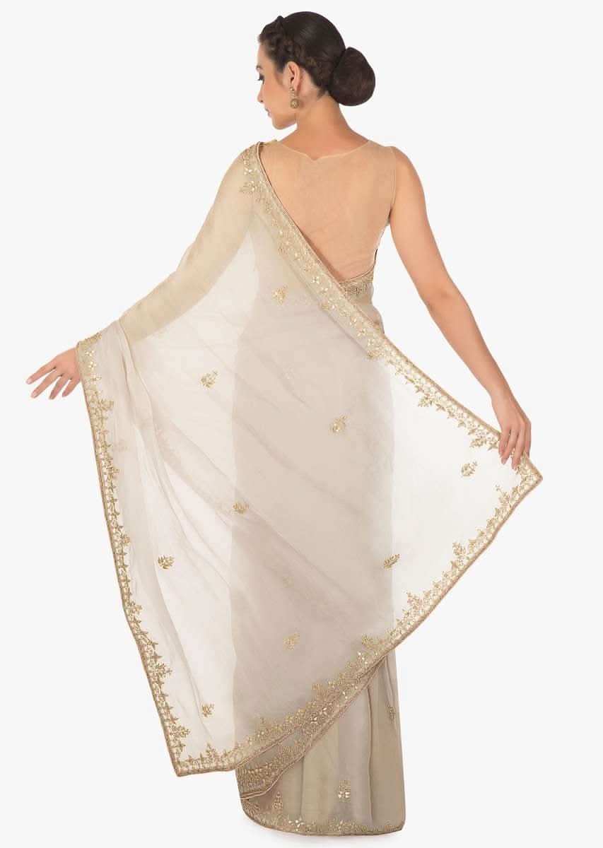Grey tissue silk saree in gotta patch and motif embroidery only on Kalki