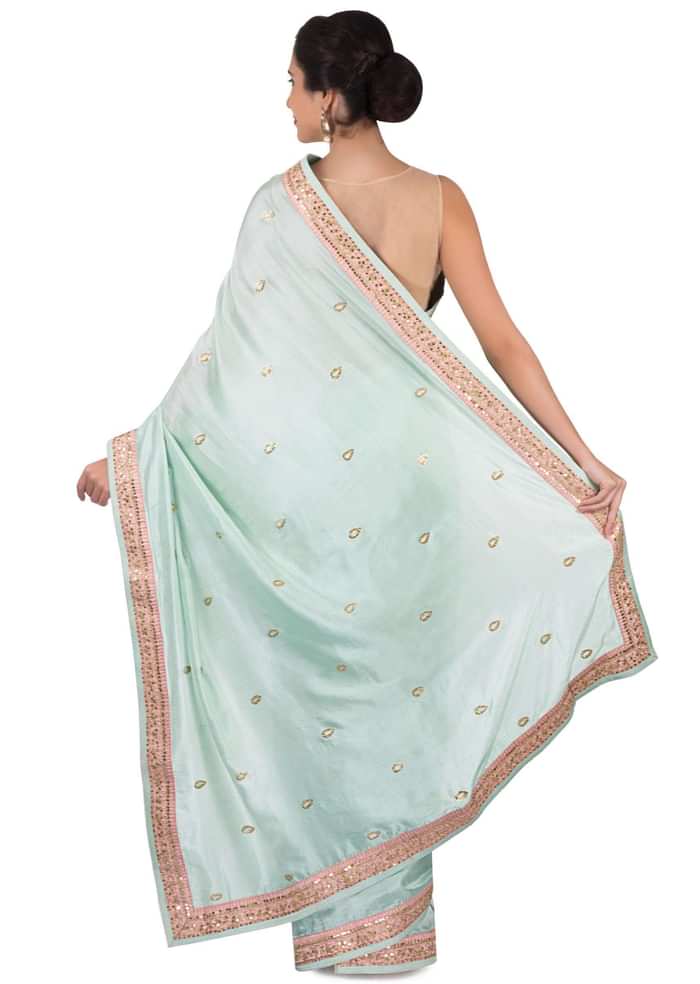 Ice blue saree in satin crepe in sequin butti and border only on Kalki