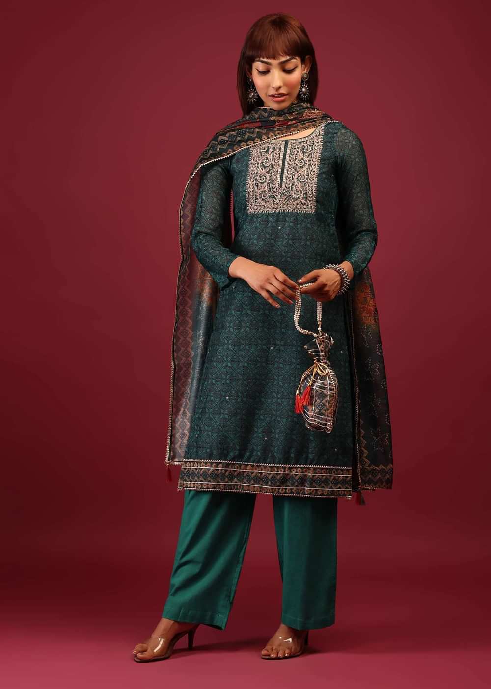 Deep Green Palazzo Suit In Tussar Silk With A Stunning Potli Bag