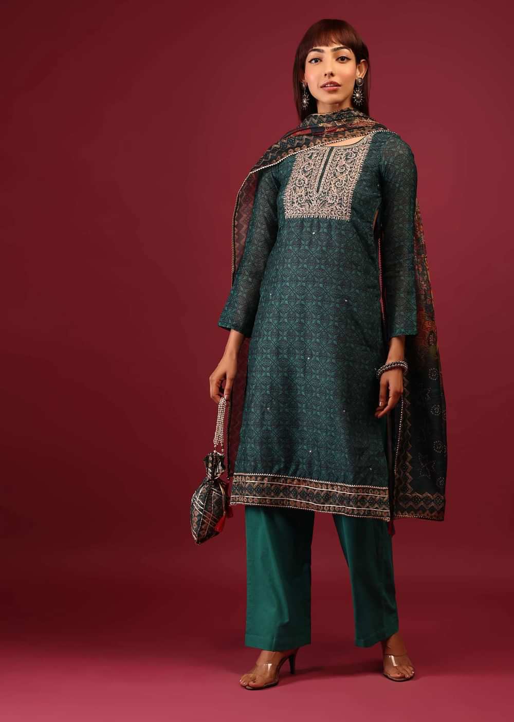Deep Green Palazzo Suit In Tussar Silk With A Stunning Potli Bag