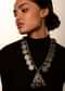 Oxidised Antique Necklace With Coins And Carved Beads Along With A Triangular Pendant Featuring Ghungru Tassels