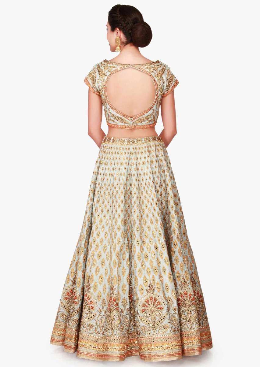 Mint blue lehenga in raw silk enhanced in zari patchwork embroidery only on Kalki