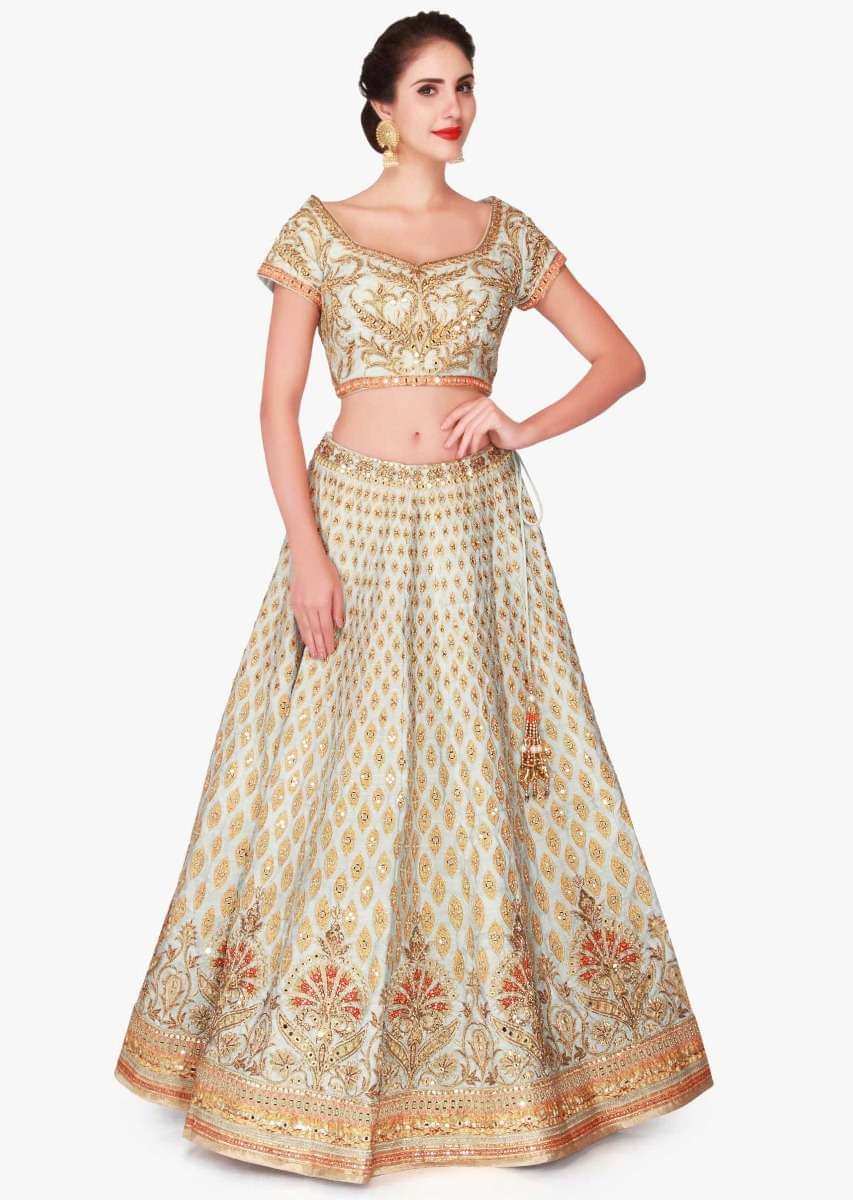 Mint blue lehenga in raw silk enhanced in zari patchwork embroidery only on Kalki