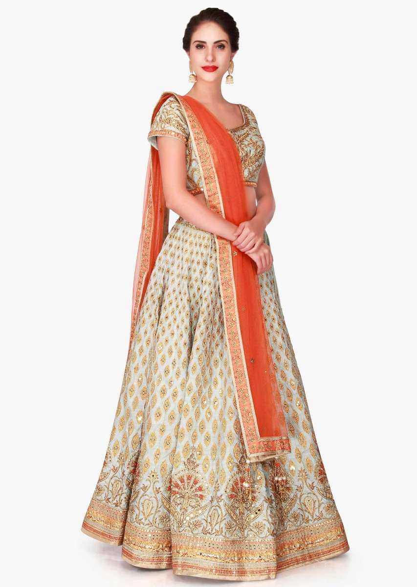 Mint blue lehenga in raw silk enhanced in zari patchwork embroidery only on Kalki
