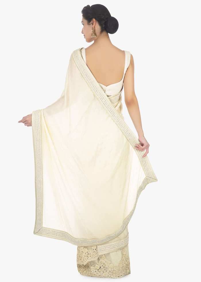 Off white half and half saree in chiffon and net saree with embellished scallop border only on Kalki