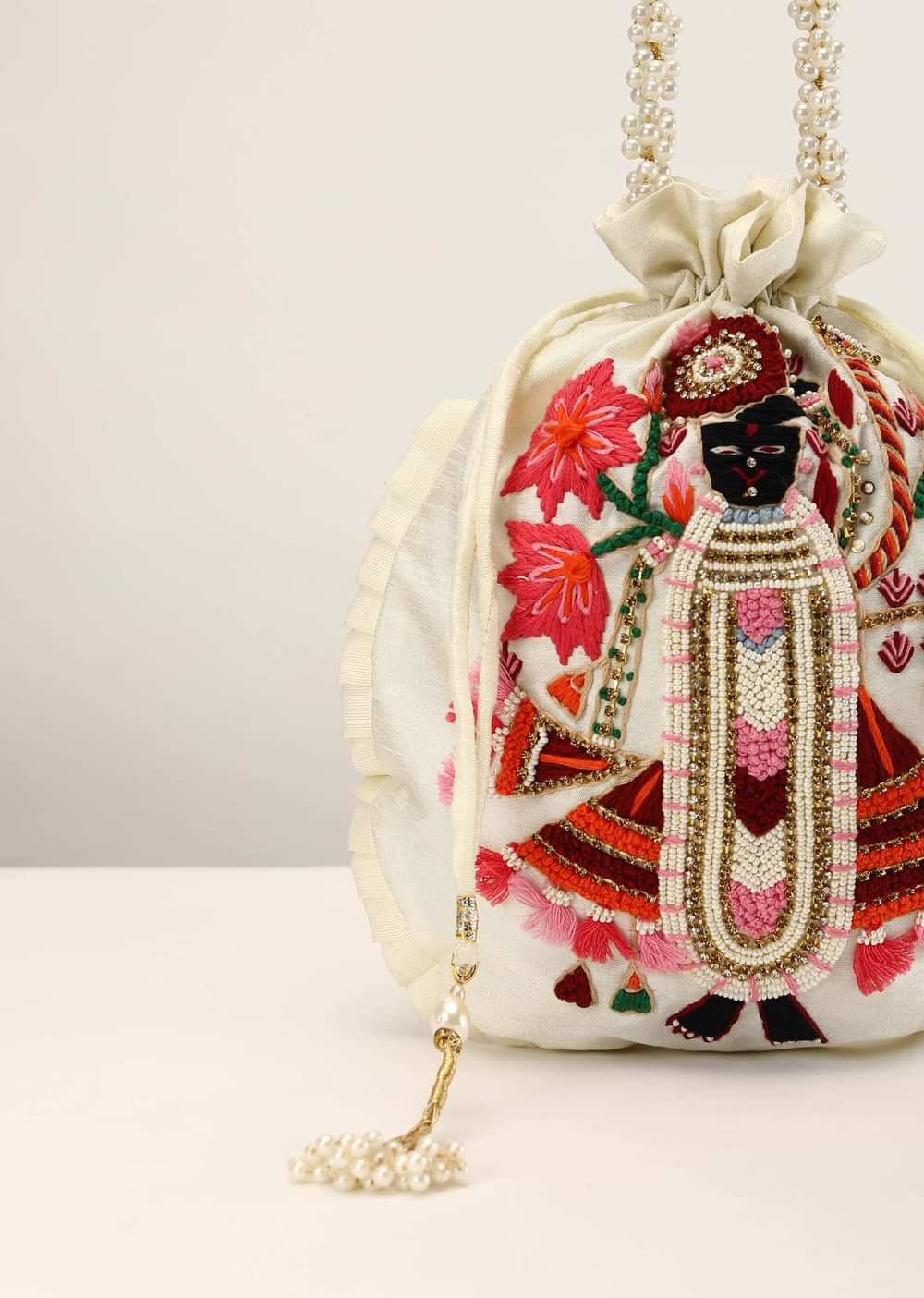 Off White Potli In Raw Silk With Hand Embroidered Goddess Motif Using Multi Colored Thread, Moti And Stone