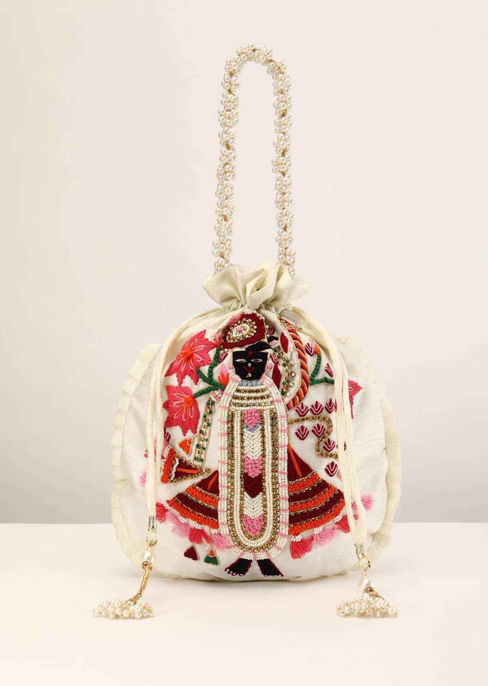 Off White Potli In Raw Silk With Hand Embroidered Goddess Motif Using Multi Colored Thread, Moti And Stone