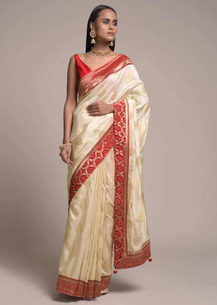 Off White Saree In Dola Silk With Brocade Leaf Shaped Buttis And Contrast Red Bandhani Border