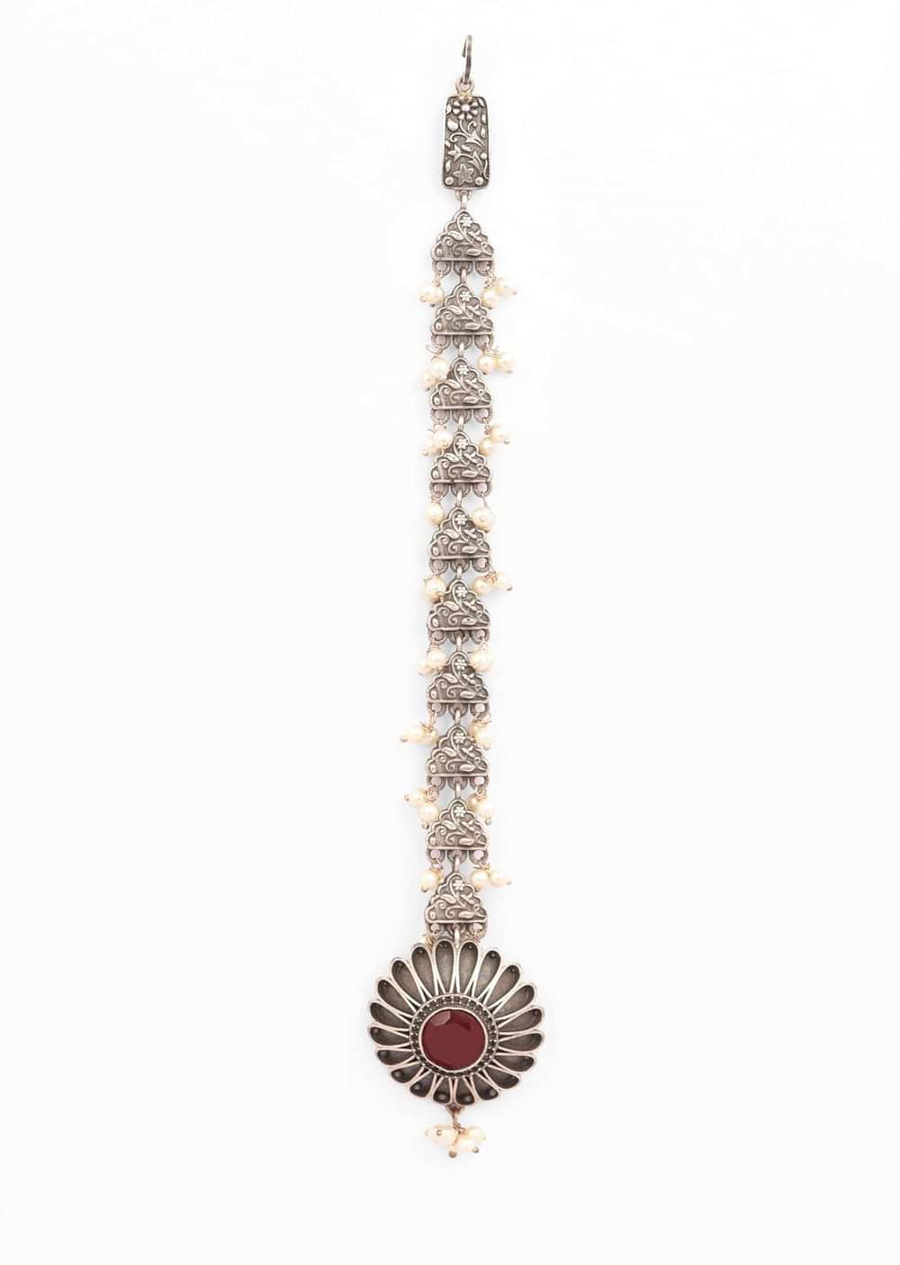 Oxidised Silver Mangtika With Carved Flower Studded In Red Stones And Pearl Tassels