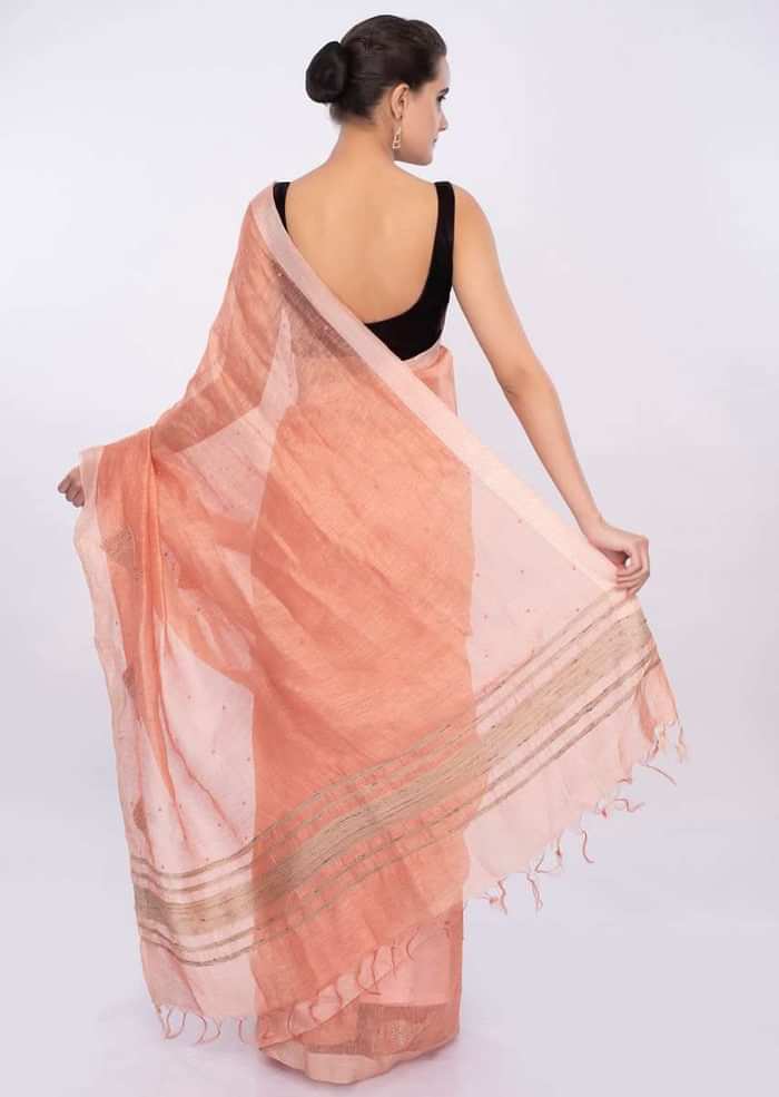 Pale orange linen saree with self moti embroidery and butti only on Kalki