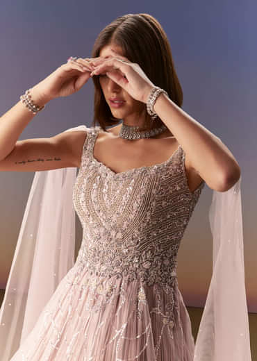 Pastel Pink Gown With Sheer Cape Drape And Heavy Embroidery