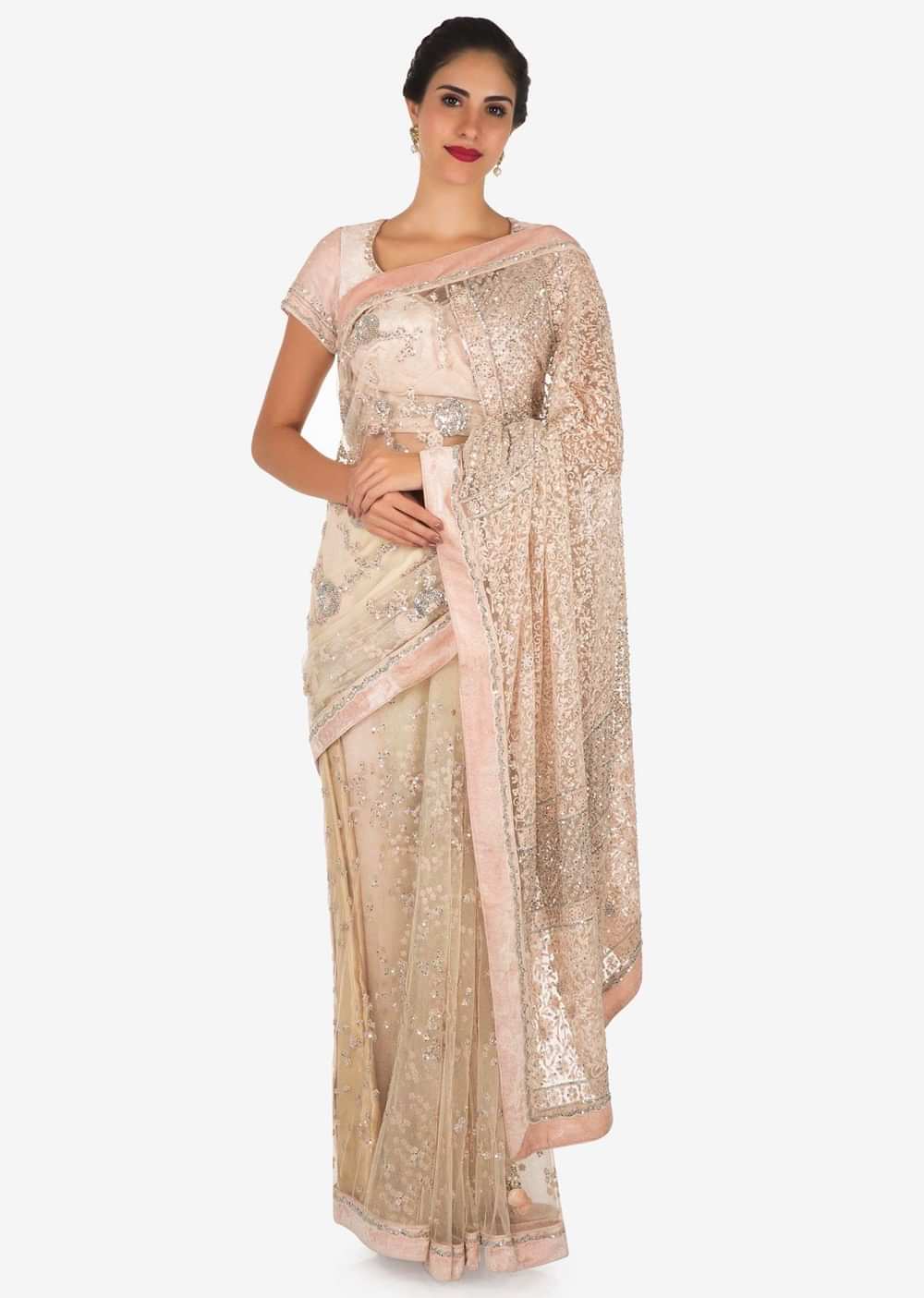 Pastel hued saree in net with velvet blouse adorn in heavy sequin and thread embroidered work only on Kalki