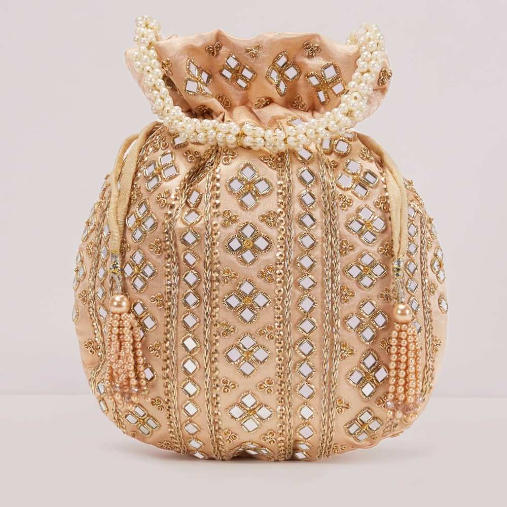Powder Peach Potli In Satin With Hand Embroidery Detailing Using Mirror And Zardosi In Geometric Design