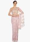 Pink saree in embroidered net encrusted in floral motifs with resham and moti work only on Kalki