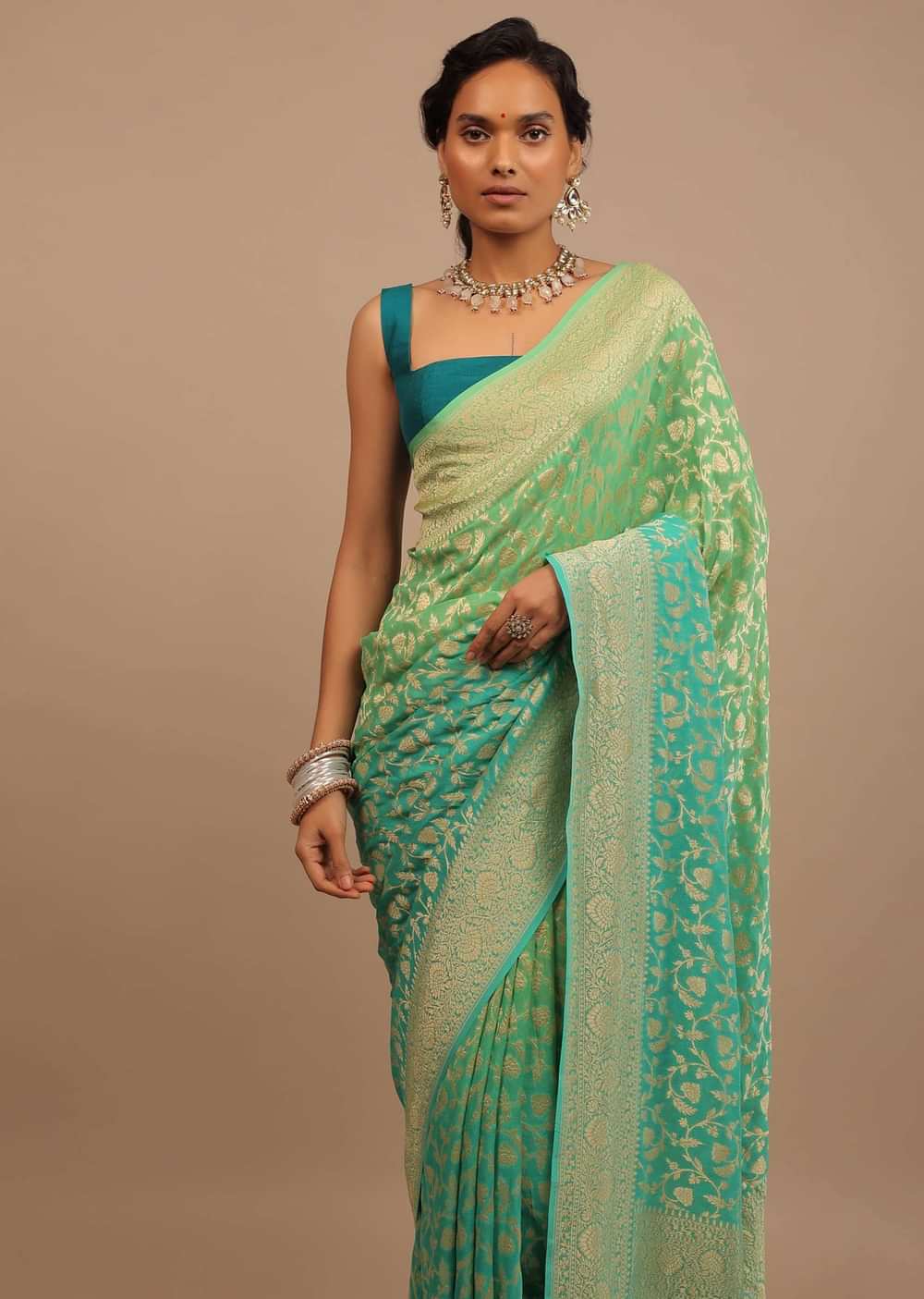 Jade Green Saree Made In Georgette And Beautified With Golden Jaal In A Floral Pattern