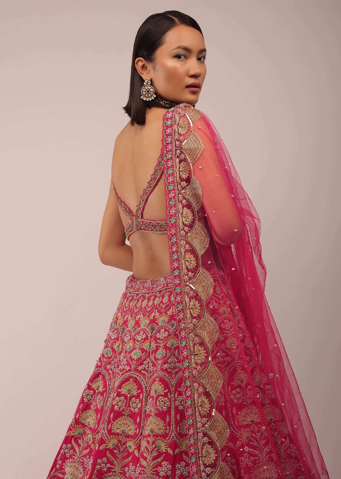 Rani Pink Lehenga In Golden Zari Work Embroidery Inspired By Mughal Architecture With Matching Net Dupatta In Embroidered Buttis
