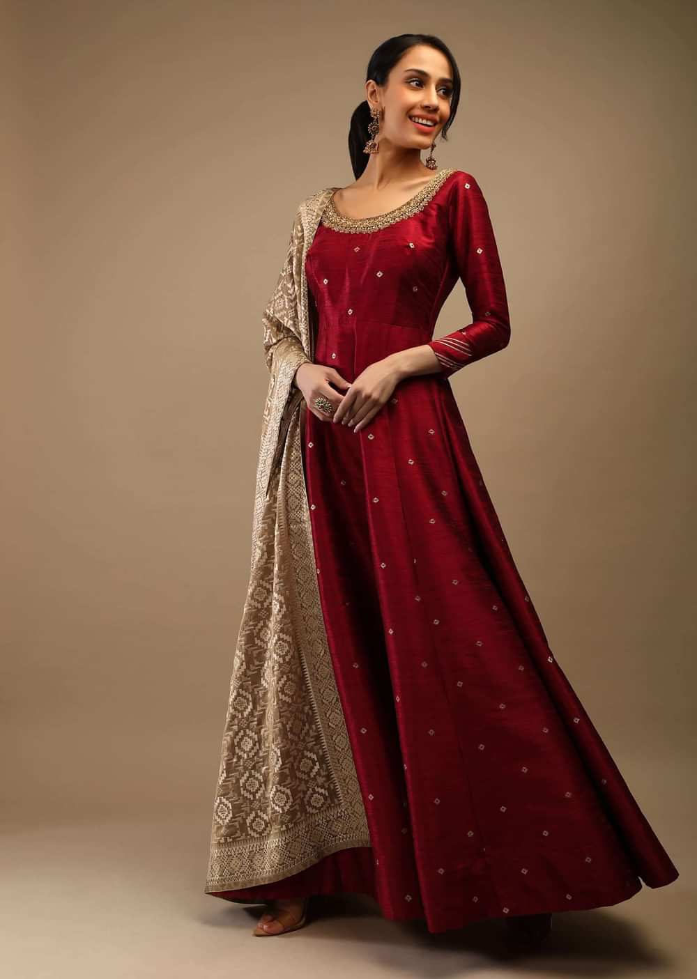 Ruby Wine Anarkali Suit In Raw Silk With Brocade Buttis, Zardosi Embroidered Neckline And Contrasting Gold Brocade Dupatta