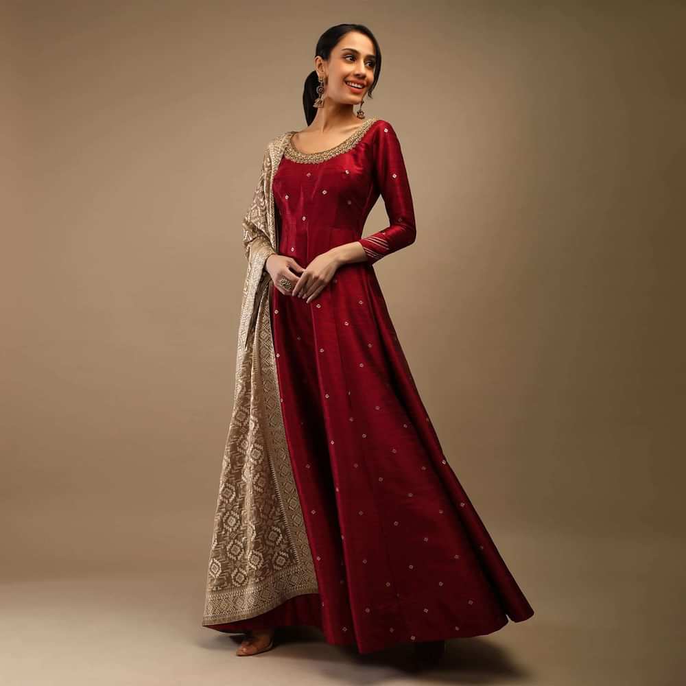 Ruby Wine Anarkali Suit In Raw Silk With Brocade Buttis, Zardosi Embroidered Neckline And Contrasting Gold Brocade Dupatta