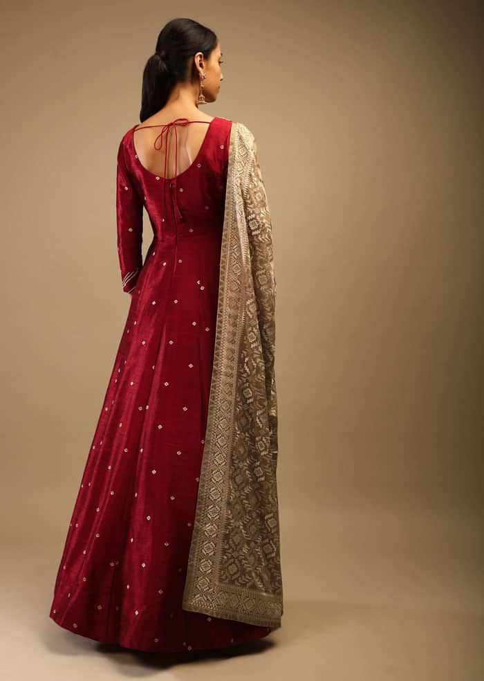 Ruby Wine Anarkali Suit In Raw Silk With Brocade Buttis, Zardosi Embroidered Neckline And Contrasting Gold Brocade Dupatta