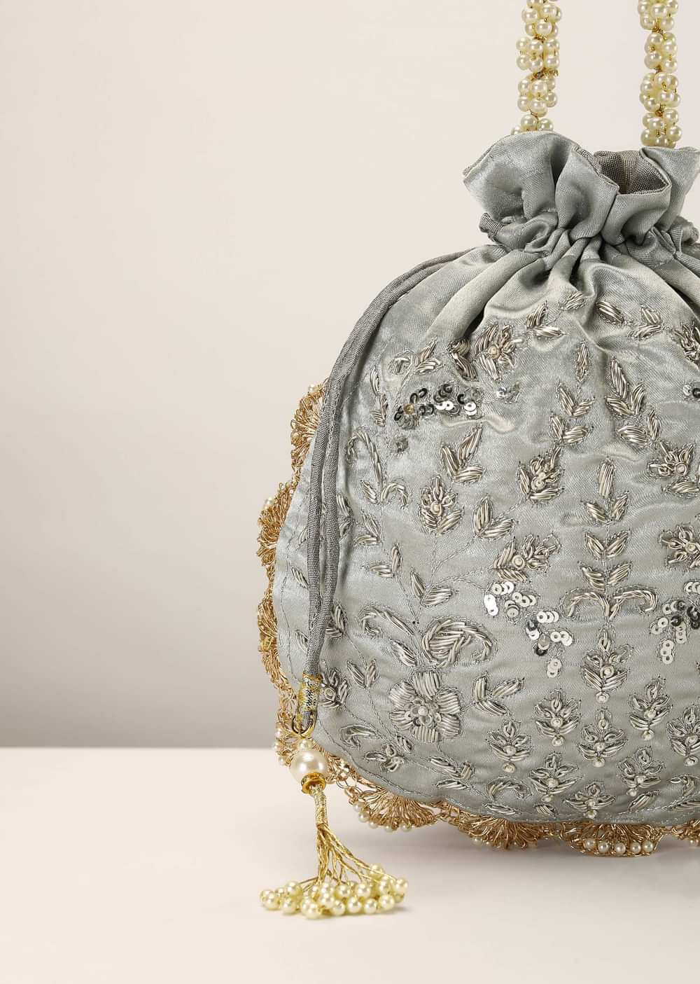 Silver Grey Potli In Satin Silk With Hand Embroidery Detailing Using Zardosi Work In Floral Design All Over