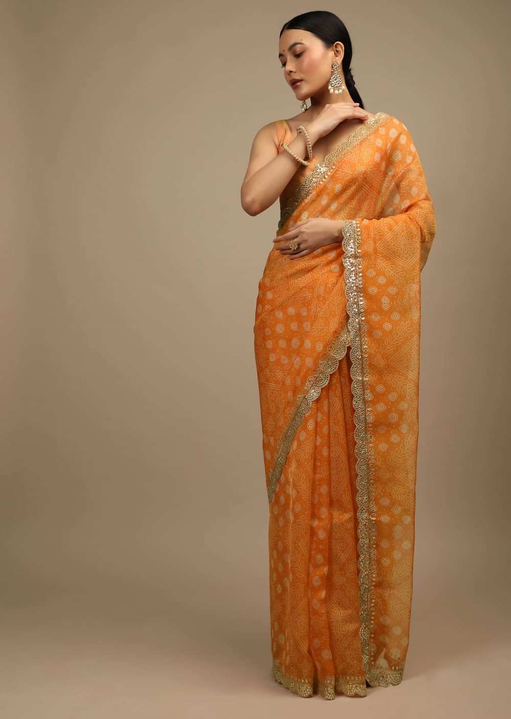 Tangerine Saree In Organza With Bandhani Buttis And Gotta Patti Embroidered Scallop Cut Border