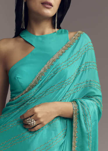 Turquoise Blue Embroidered Chinon Saree With Wavy Border