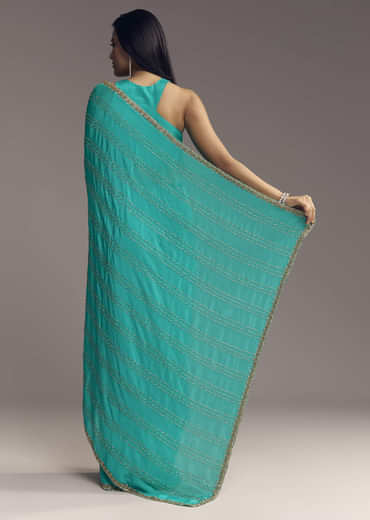 Turquoise Blue Embroidered Chinon Saree With Wavy Border