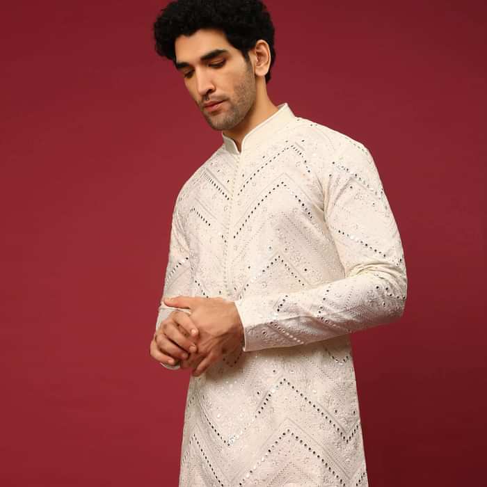 White Kurta Set In Raw Silk Heavily Embroidered With Resham And Mirror Embroidery In Floral And Chevron Design