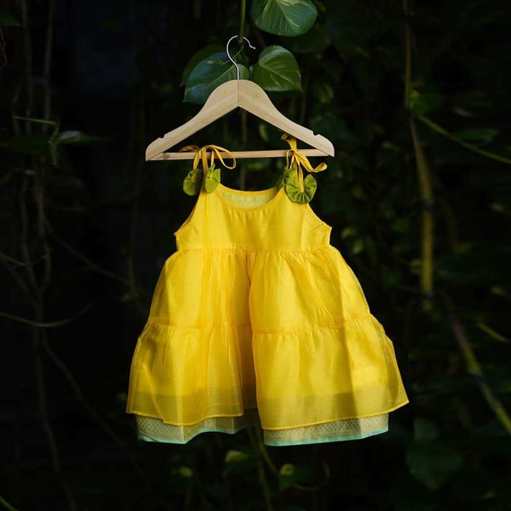 Kalki Girls Yellow Tiered Dress In Cotton Silk With Adjustable Green Tie Ups On The Shoulder By Love The World Today