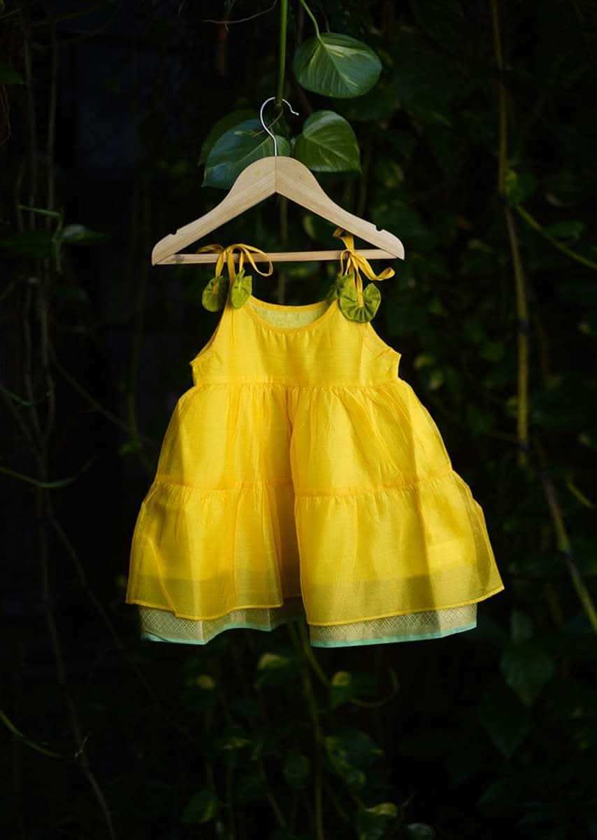 Kalki Girls Yellow Tiered Dress In Cotton Silk With Adjustable Green Tie Ups On The Shoulder By Love The World Today